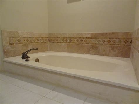 finished bathtub backsplash  travertine tile