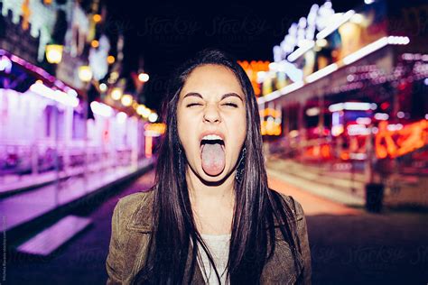 girl sticking tongue   stocksy contributor michela ravasio
