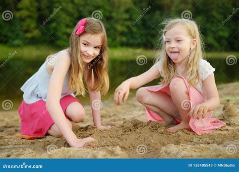 Dos Hermanas Jovenes Que Se Divierten En Una Playa Arenosa Del Lago En