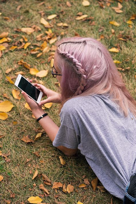 Pink Haired Woman With Braid Using Mobile Phone By Stocksy