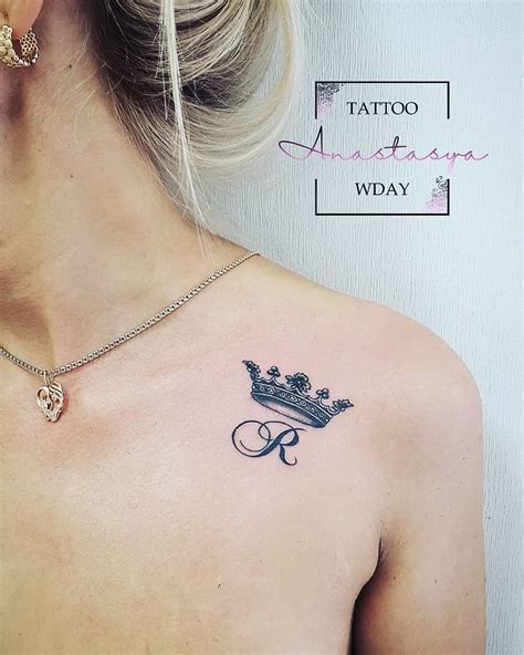A Woman With A Crown Tattoo On Her Back Shoulder And Upper Part Of The
