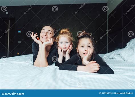 Mom And Two Daughters Have Fun On The Bed Stock Image Image Of