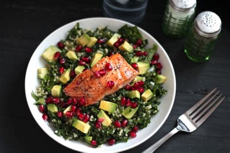 a beautiful and nutritious salad with five superfoods kale quinoa avocado pomegranate and