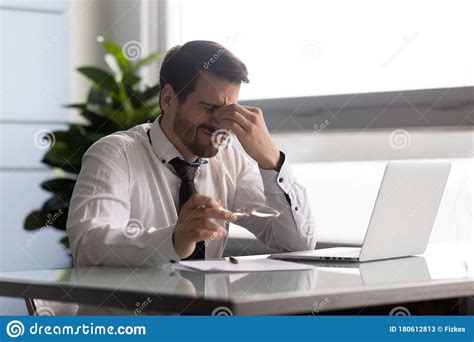 Stressful Businessman Taking Off Glasses Suffering From Dry Eyes