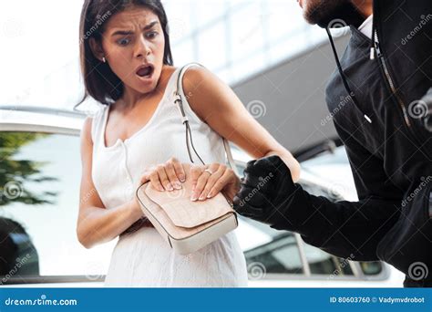 Frightened Shocked Young Woman Being Robbed By Thief Outdoors Stock