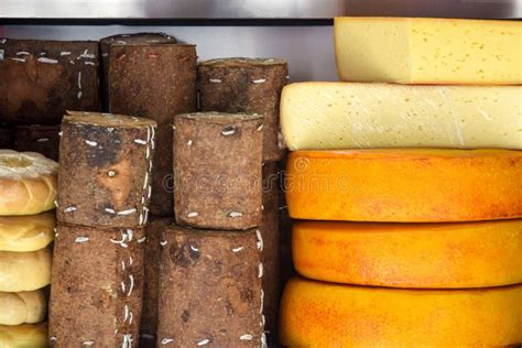 Cheese Heads Of Different Colors And Sizes Are Stacked On Counter Fair