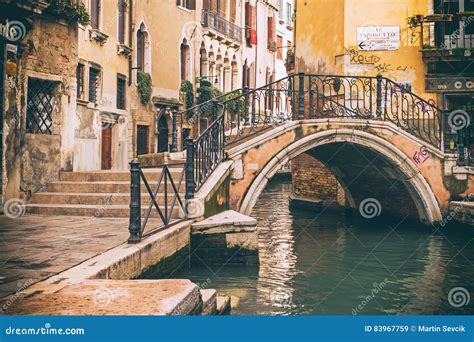 arch bridge   narrow canal  venice italy editorial stock image