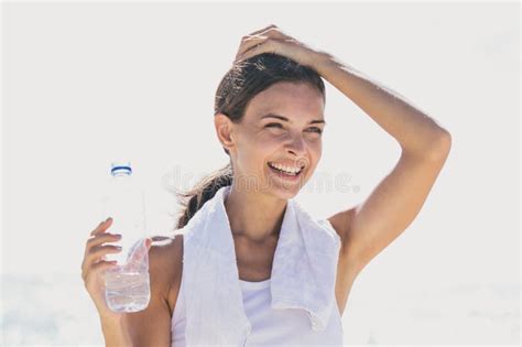 Happy Sporty Woman Holding A Bottle Of Mineral Water For Refresh Stock