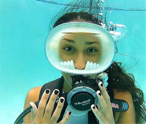 a woman holding a camera under the water