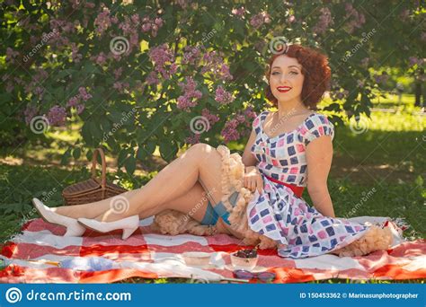 red haired happy pin up girl in vintage summer dress and