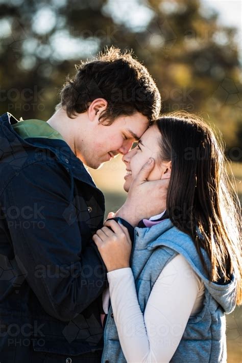 Image Of Young Couple Standing Close Together Foreheads Touching Him