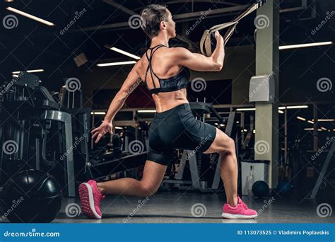 Female Doing Workouts With Trx Suspension Strips In A Gym Club Stock