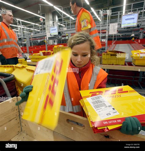 employees  german logistics group dhl sort mail   dhl hub  stock photo royalty