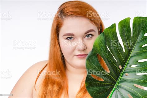 Nicelooking Fat Redhead Woman In Spa Towel With Tropical Leaf Isolated