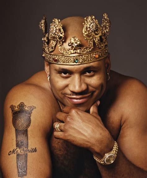 A Shirtless Man With A Crown On His Head And Tattoos Is Posing For The