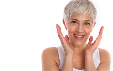 joyful mature woman touching her face healthy skin natural on white