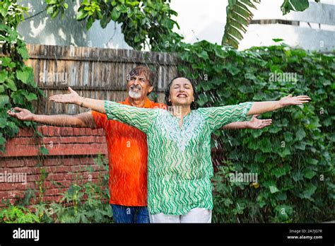 Happy Senior Couple Arms Outstretched Standing Together Having Fun