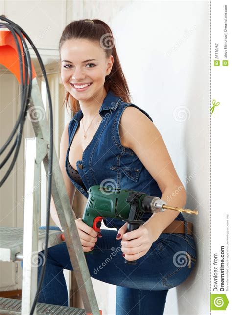 Portrait Of Girl In Overalls With Drill Royalty Free Stock