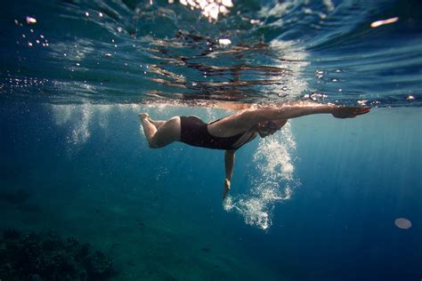 Person Swimming Underwater In Ocean