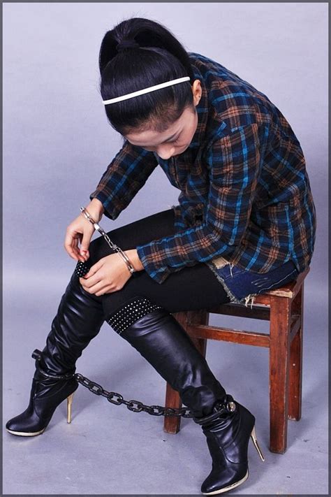 asian women in handcuffs looking at her heavy chinese style leg irons handschellen