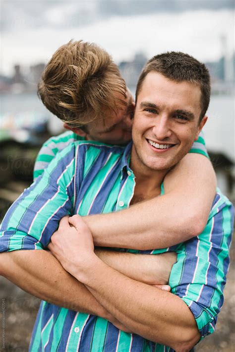 «happy Gay Couple Hugging Outdoors Del Colaborador De Stocksy «simone