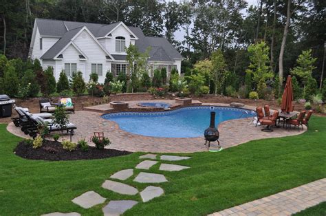 landscaped backyard design   form vinyl pool spillover spa