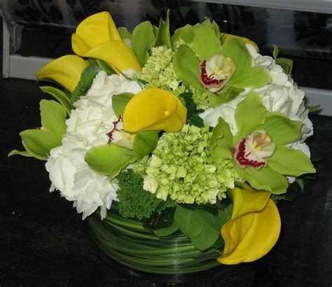 This Is A Floral Arrangement That Features Yellow Miniature Calla