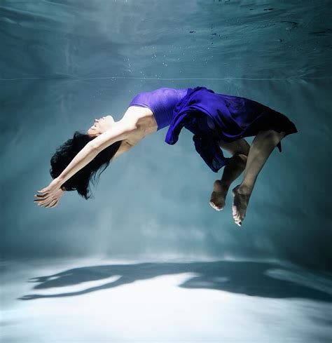 woman floating underwater side view  henrik sorensen