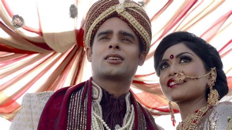shot of indian bride and groom in traditional wedding dress posing
