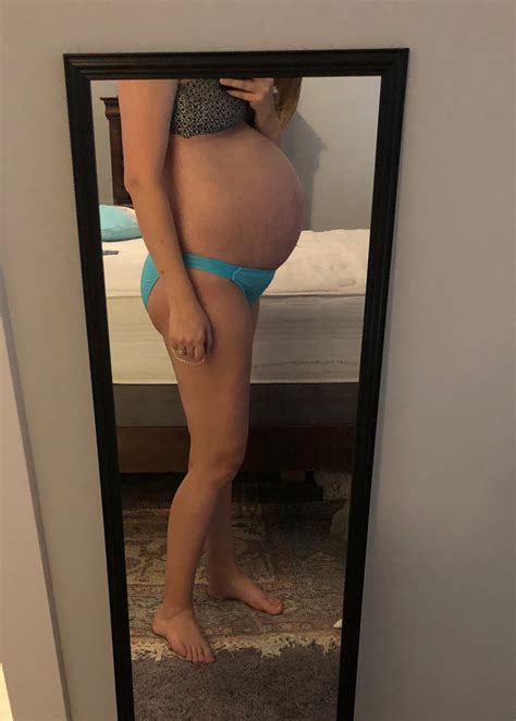 my 37 week pregnant wife showing off her bump in a bikini