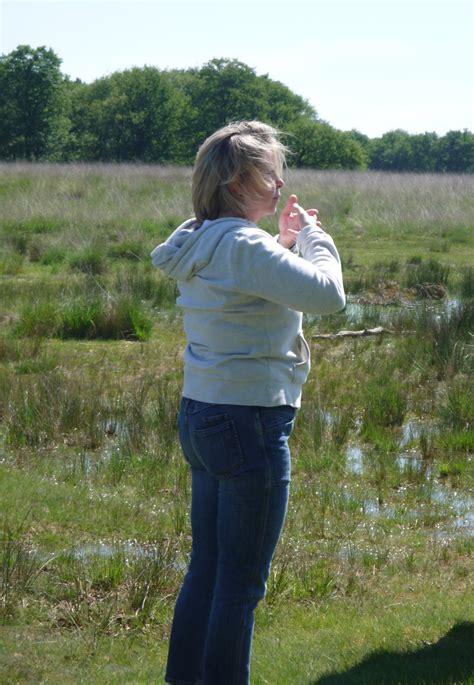 woman standing   grass   hands