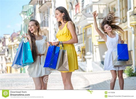 Fun Began Three Girls Holding Shopping Bags And Walk Around The Stock