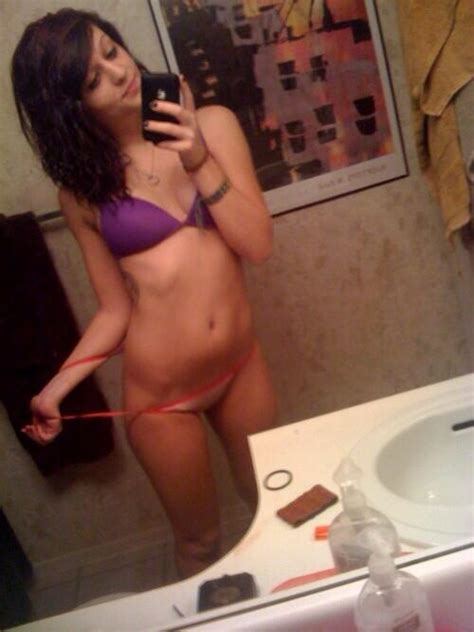 smiling emo brunette teen about to take off her panties