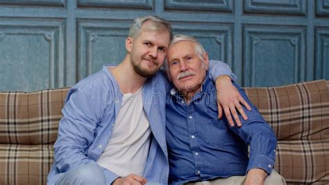 Joyful Excited Young Man Embracing Gray Haired Old Dad Or Grandfather