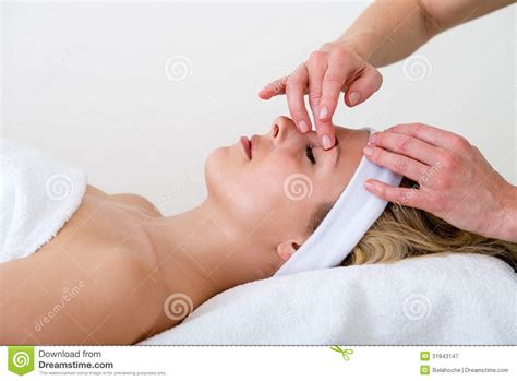 Masseuse Massaging A Woman Eyebrow Area Royalty Free