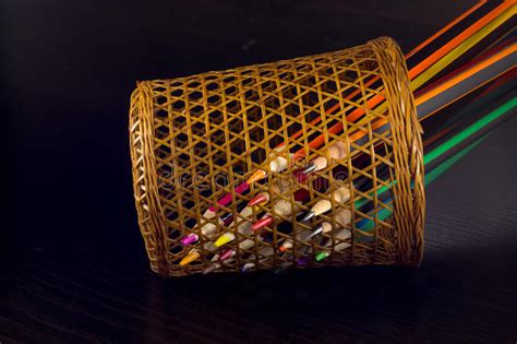 Colored Pencils Are Visible Through A Wicker Glass Stock