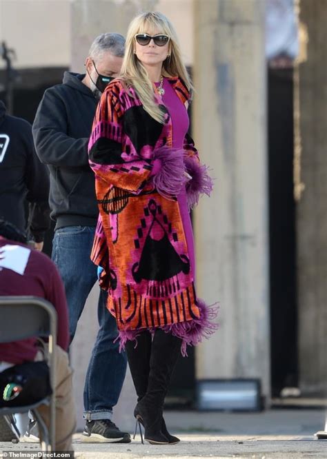 heidi klum flaunts her sense of style in a colorful coat on the set of