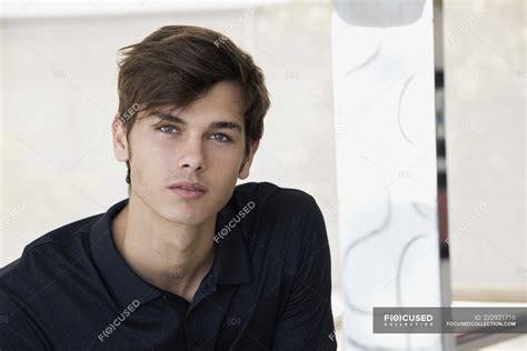 portrait  handsome young man  black polo shirt male  confidence stock photo