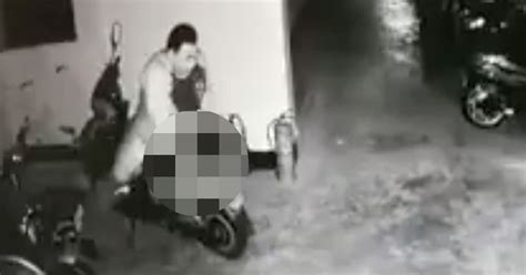 randy man drops his trousers and has sex with motorbike in full view of cctv cameras mirror online