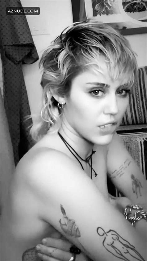 miley cyrus poses topless covering her nude tits with