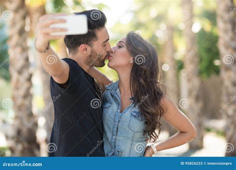 Young Couple Kissing Each Other Posing To Selfie Stock Image Image Of