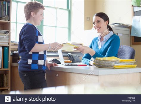 student handing  homework  teacher stock photo royalty  image