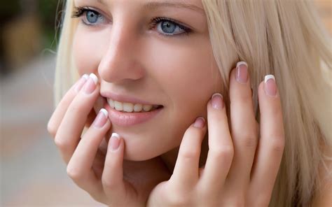 women model blonde long hair face open mouth teeth hand looking away long nails blue