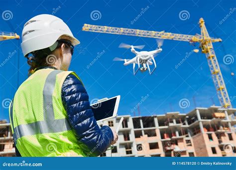 drone inspection operator inspecting construction building site flying