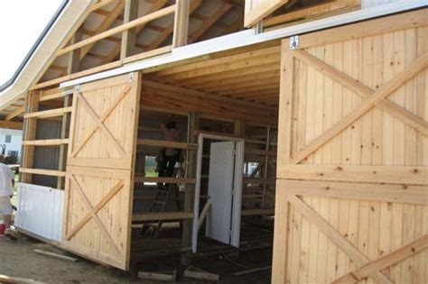 exterior sliding barn door hardware  crossed braces  unpainted sliding doors