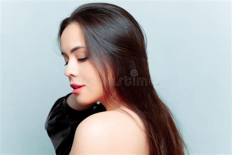 Portraits Of A Beautiful Brunette Model Who Stands Sideways And