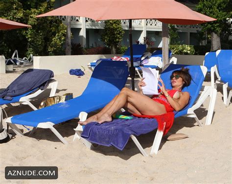 lizzie cundy reading a script on her sun lounger while holidaying on