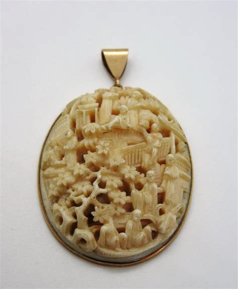 lot carved ivory pendant set  marked ct gold
