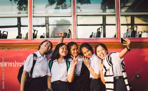 Thai School Girl Group Making Selfie Together At The Bus Stop