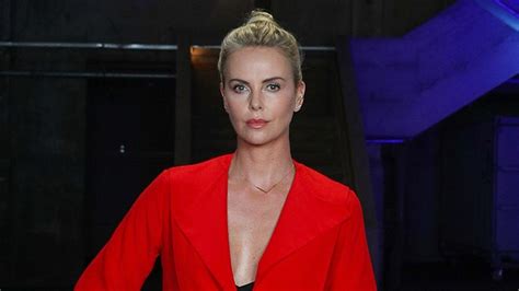 charlize theron looks red hot at atomic blonde event in